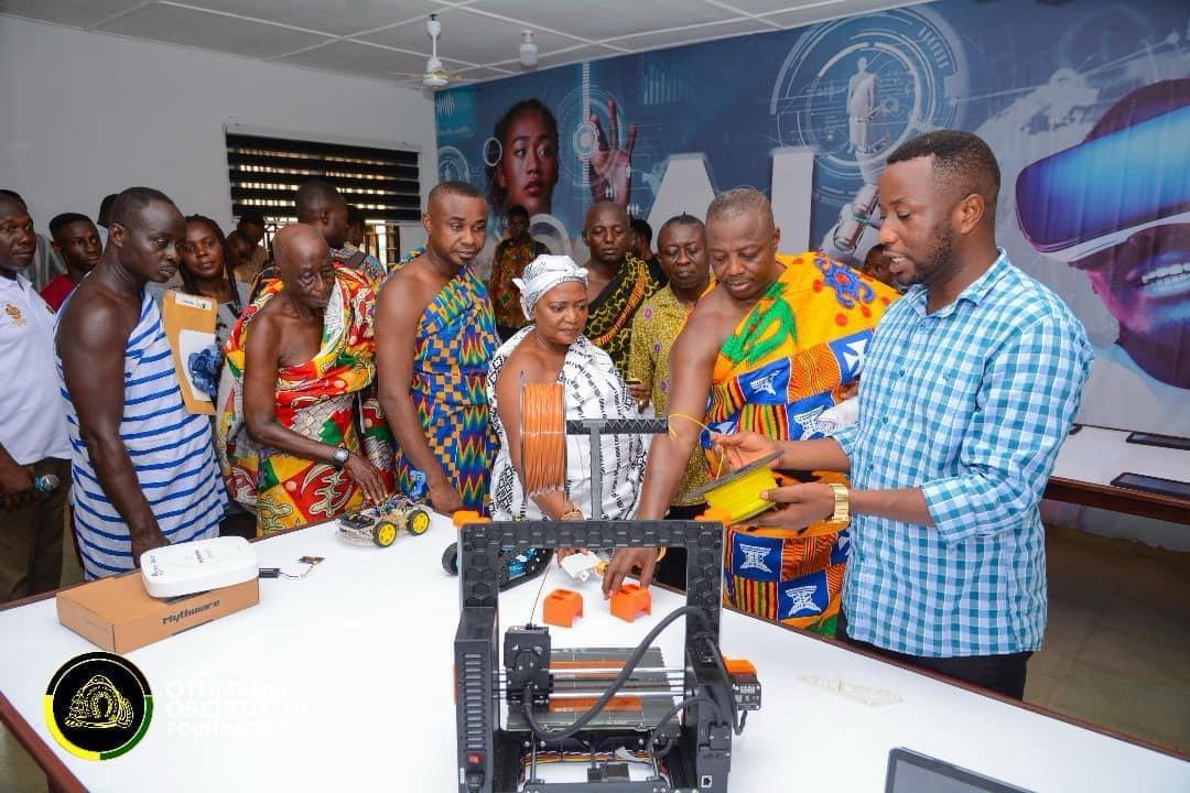 MakersPlace CEO explaining a 3D printer to a Chief from the Ashanti Region and guests
